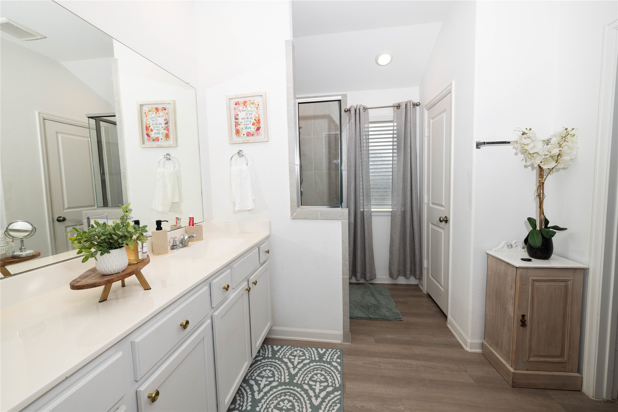 5715 Prairie Chapel Road Katy, TX 77493 - Photo 15 of 30 a bathroom with a sink a mirror and a potted plant