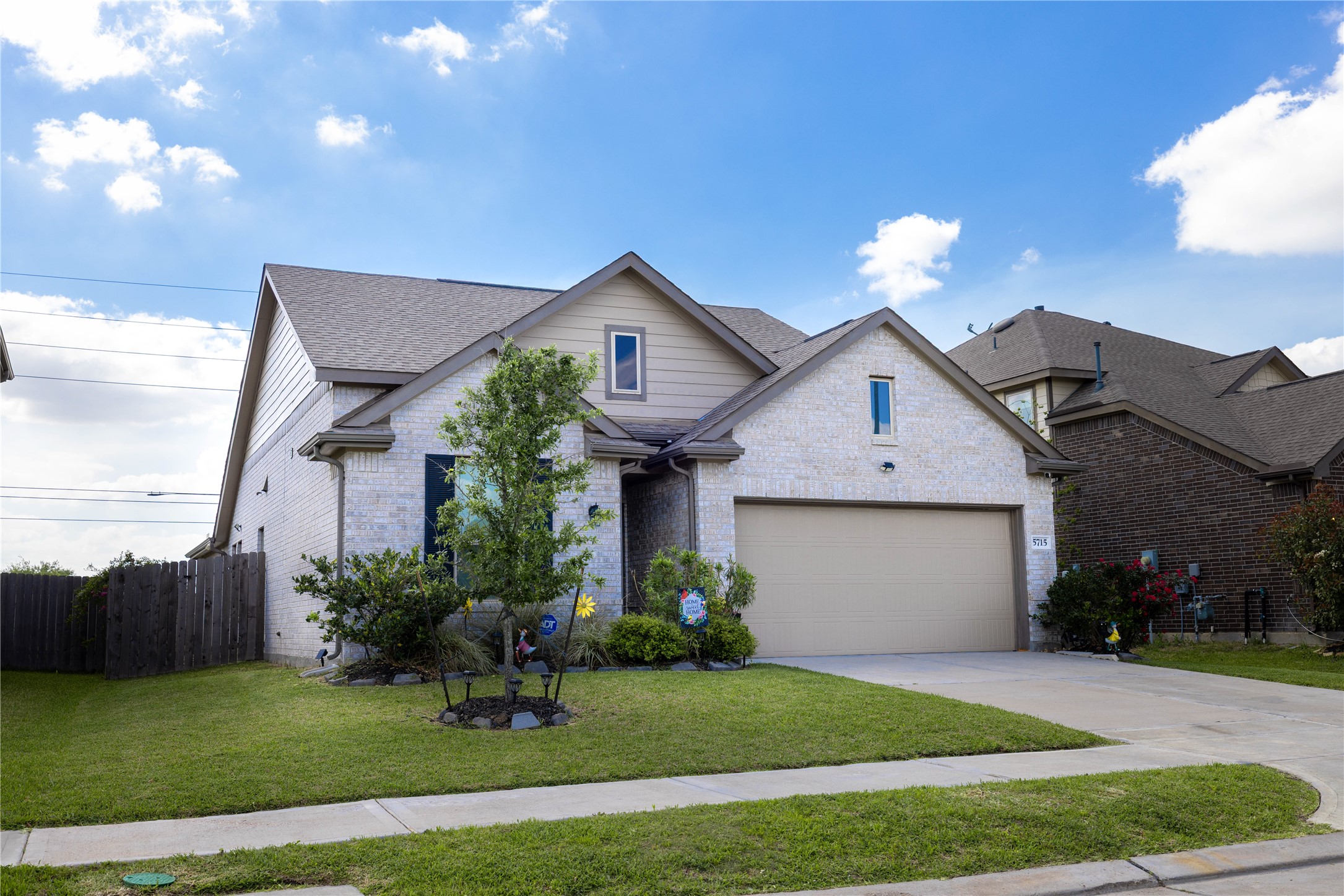 5715 Prairie Chapel Road Katy, TX 77493 - Photo 3 of 30 a front view of a house with a yard and garage