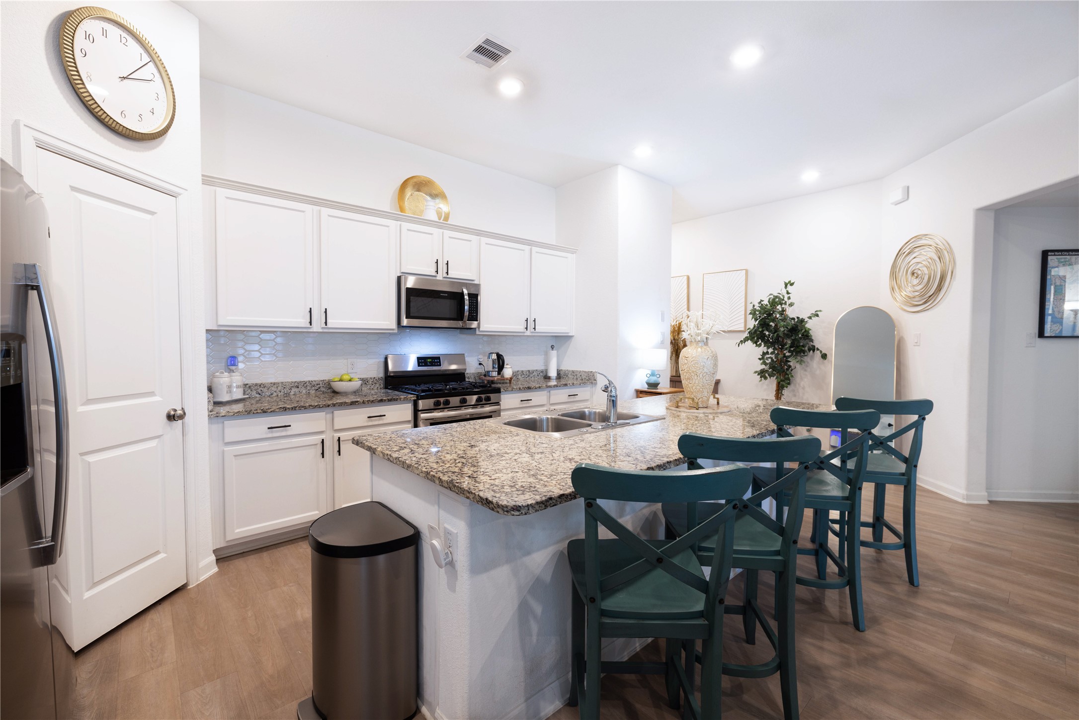 5715 Prairie Chapel Road Katy, TX 77493 - Photo 6 of 30 a kitchen with a table chairs microwave and cabinets