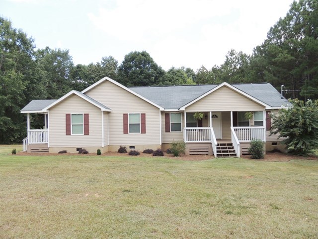 627 Old Cabaniss Road Forsyth, GA 31029 - Photo 1 of 20 a front view with a house and garden