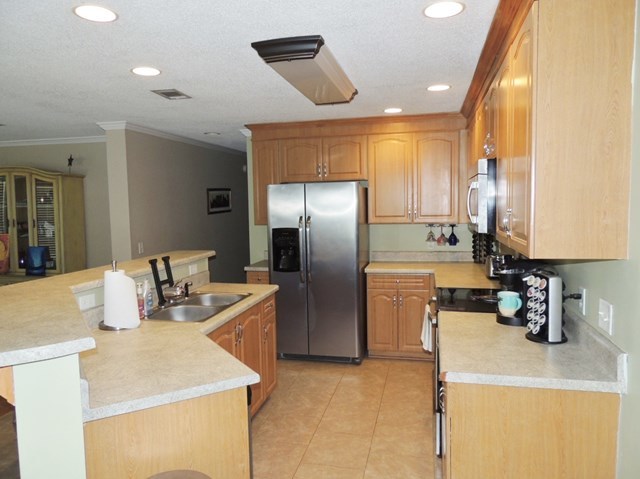 627 Old Cabaniss Road Forsyth, GA 31029 - Photo 2 of 20 a kitchen with a sink a refrigerator and a stove top oven