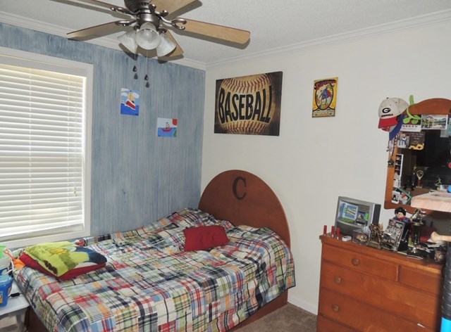 627 Old Cabaniss Road Forsyth, GA 31029 - Photo 11 of 20 a bedroom with a bed and wooden floor