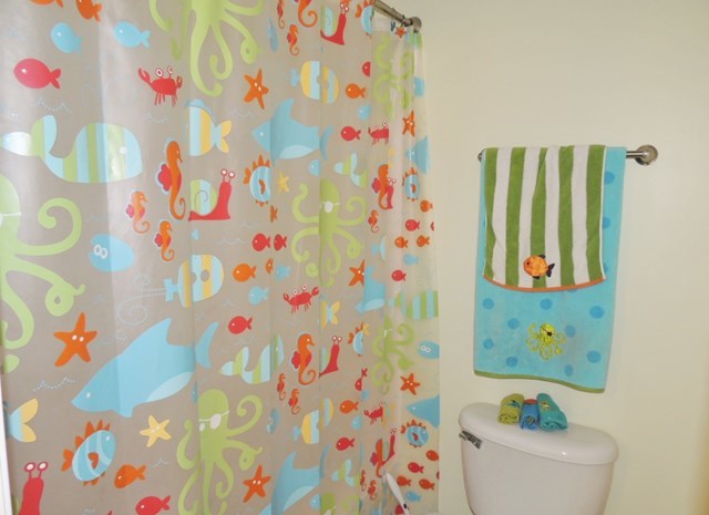 627 Old Cabaniss Road Forsyth, GA 31029 - Photo 14 of 20 a bathroom with a bathtub and a shower curtain