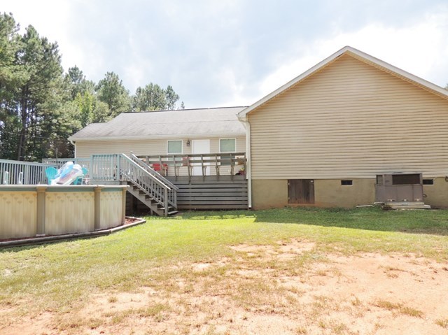 627 Old Cabaniss Road Forsyth, GA 31029 - Photo 16 of 20 a view of a backyard with a garden and deck