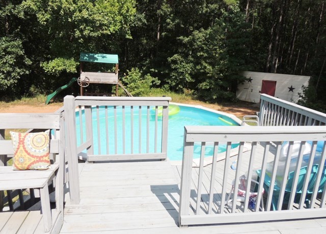 627 Old Cabaniss Road Forsyth, GA 31029 - Photo 17 of 20 a view of deck with furniture and trees