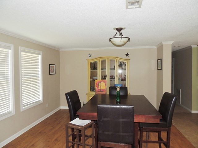 627 Old Cabaniss Road Forsyth, GA 31029 - Photo 4 of 20 a dining room with furniture wooden floor and a rug