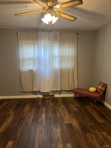 a view of a room with wooden floor