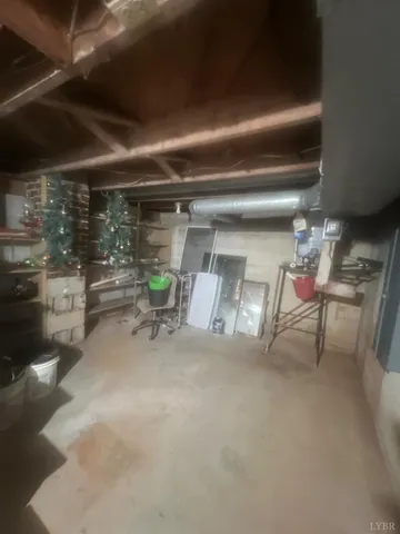 a room with furniture a rug and white walls