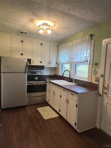a kitchen with cabinets and wooden floor