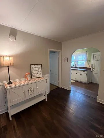 a view of a bedroom with furniture and wooden floor