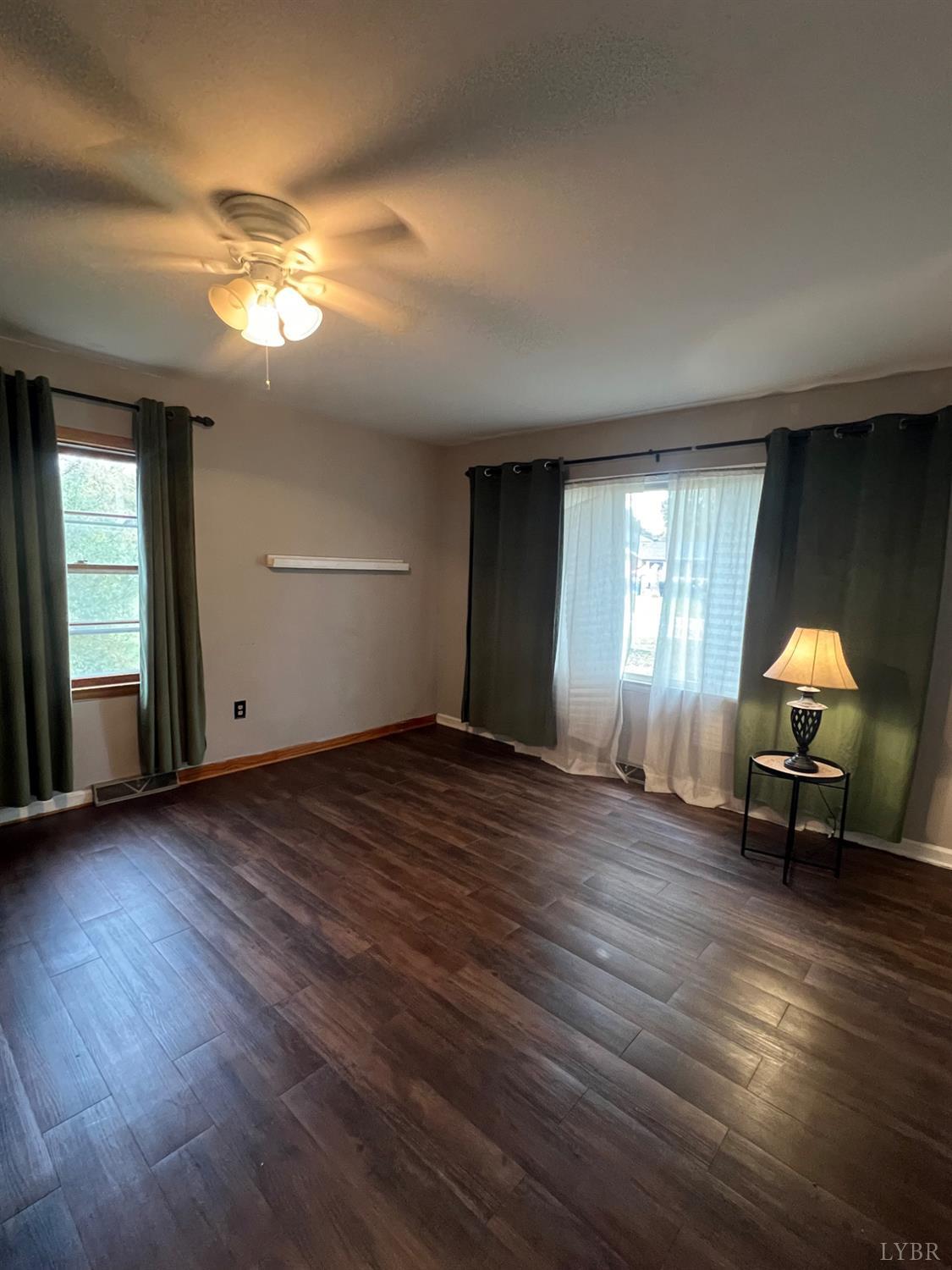 1573 Grit Road Hurt, VA 24563 - Photo 10 of 31 a view of an empty room with wooden floor and a window
