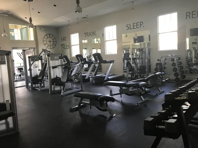 a room with gym equipment and a large window