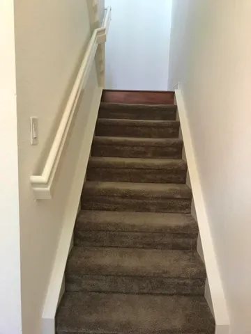 an empty room with fan and windows