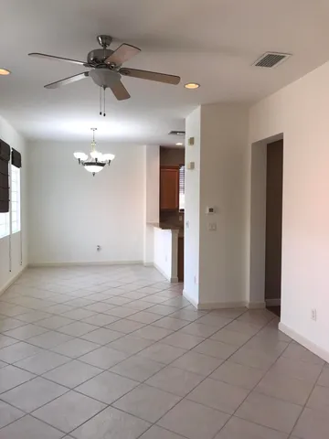 an empty room with a bathroom and mirror