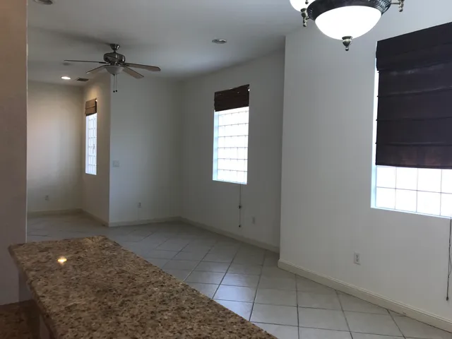 a kitchen with granite countertop a stove sink microwave and cabinets