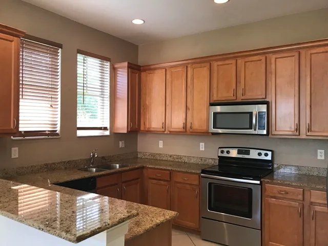 a kitchen with a refrigerator stove and cabinets