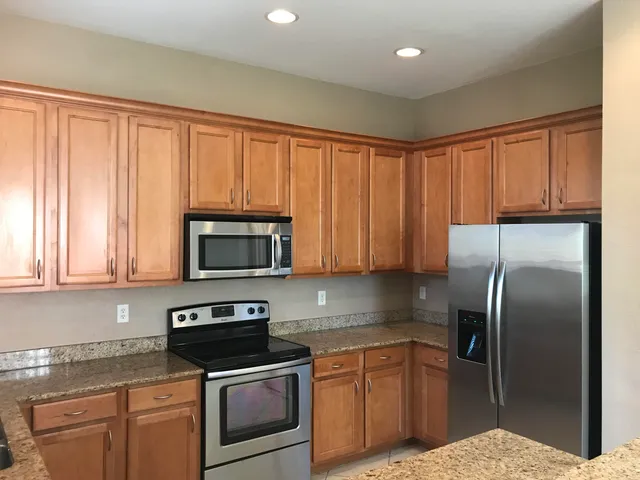 an empty room with wooden floor and closet
