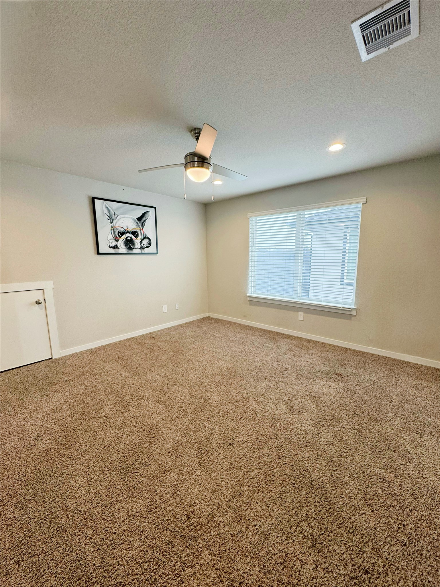 12711 Basinghall Lane Houston, TX 77047 - Photo 15 of 25 an empty room with a ceiling fan and window