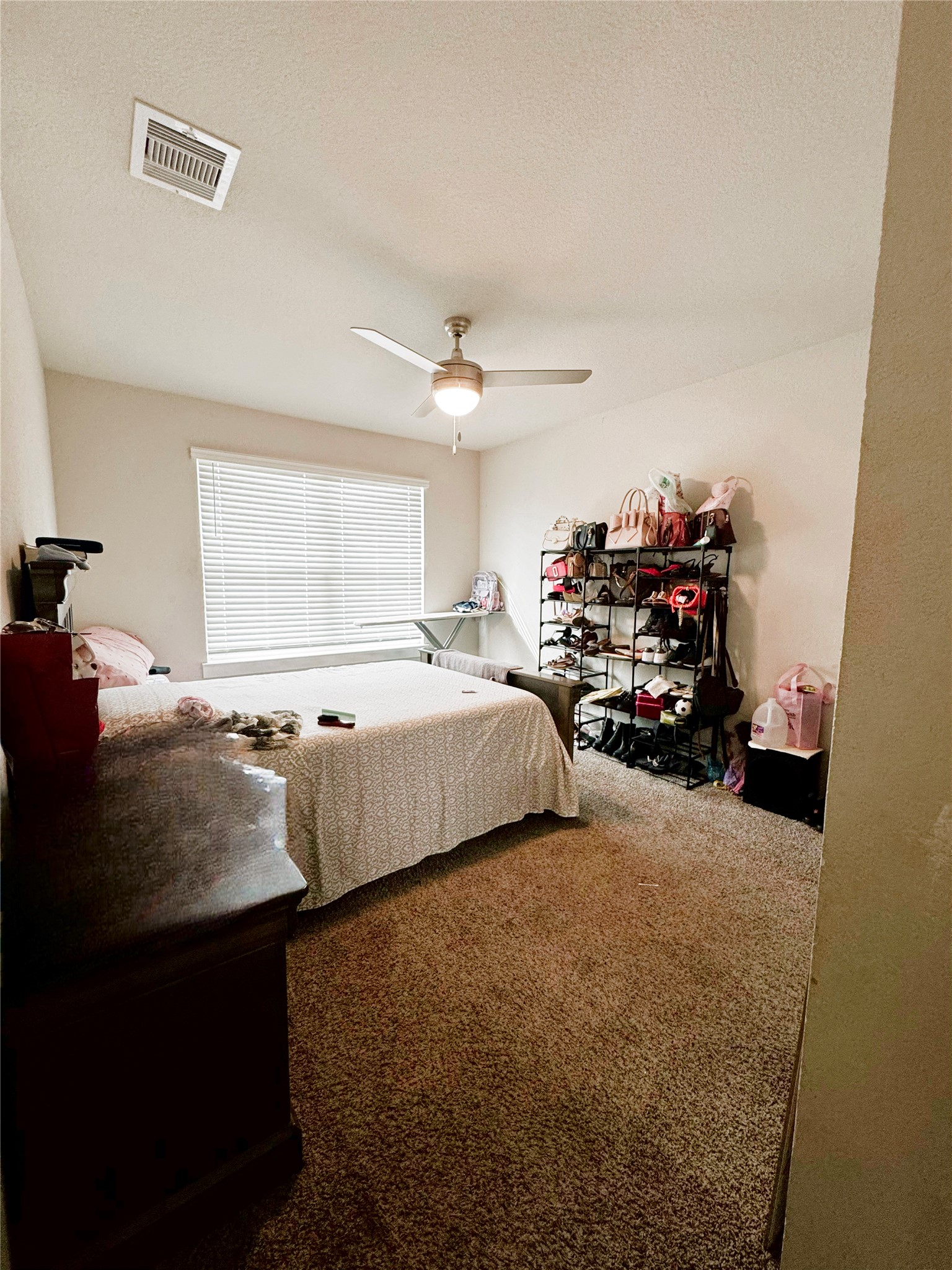 12711 Basinghall Lane Houston, TX 77047 - Photo 22 of 25 a bedroom with bed and window