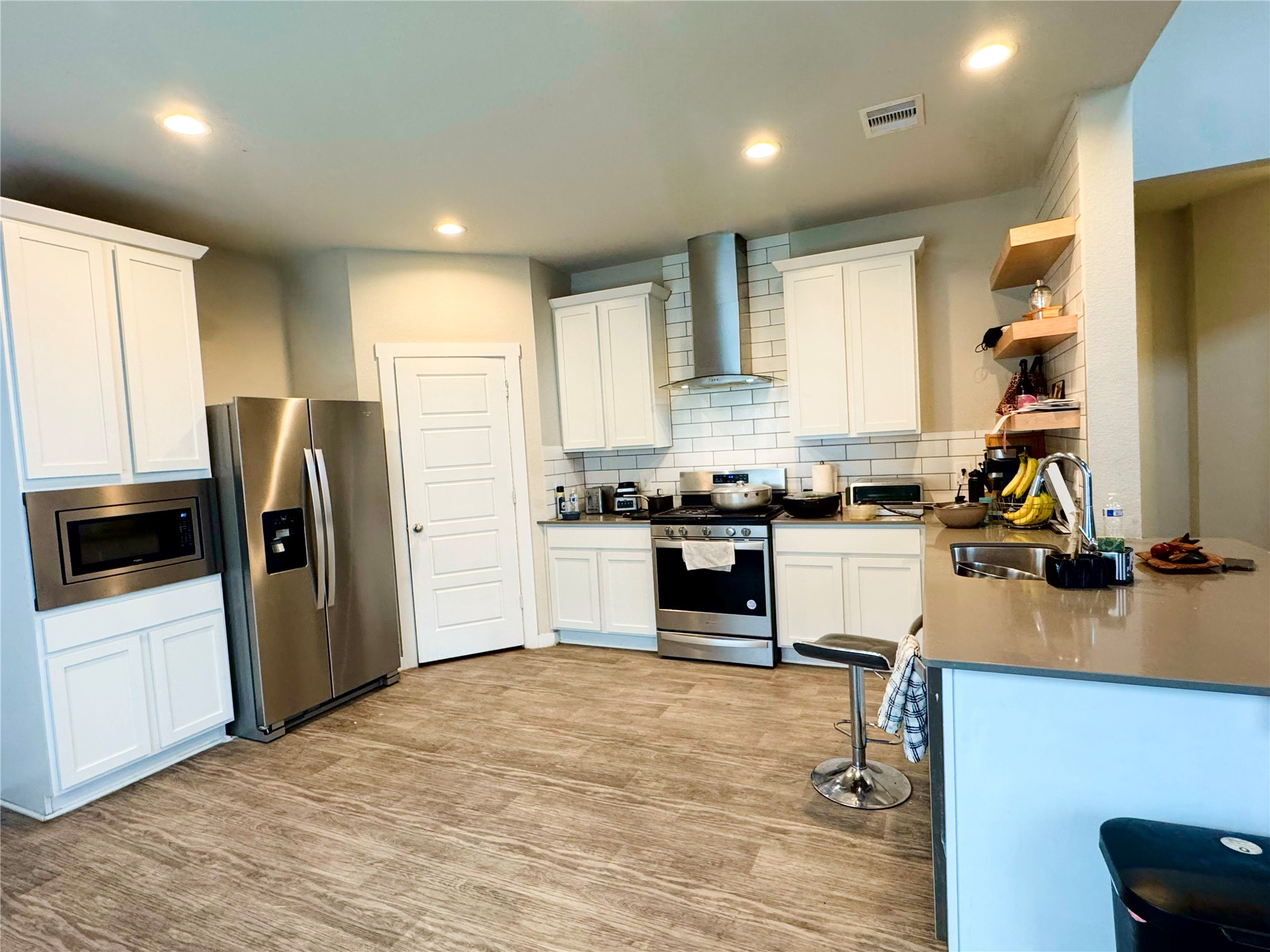 12711 Basinghall Lane Houston, TX 77047 - Photo 8 of 25 a kitchen with a refrigerator and a stove top oven