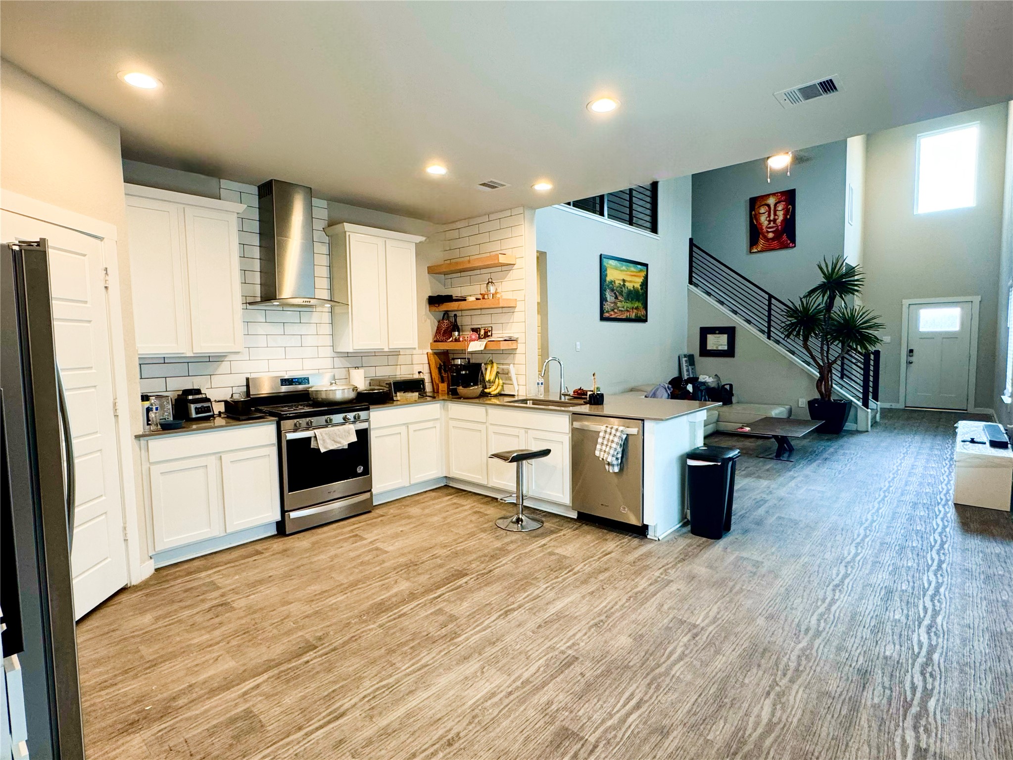 12711 Basinghall Lane Houston, TX 77047 - Photo 10 of 25 a kitchen with stainless steel appliances kitchen island granite countertop a stove and a refrigerator