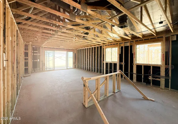 a view of a hall with wooden floor and staircase