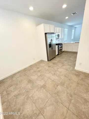 a kitchen with stainless steel appliances a refrigerator and a stove top oven