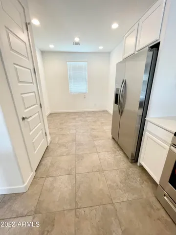 a kitchen with kitchen island a sink a stove and refrigerator