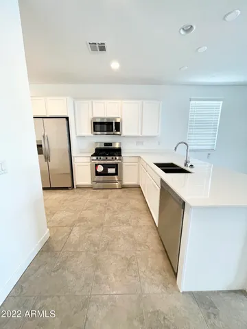 a view of a livingroom with furniture and a ceiling fan