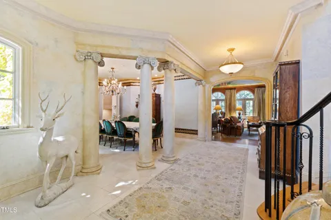 a large kitchen with stainless steel appliances a large counter top a stove and a sink