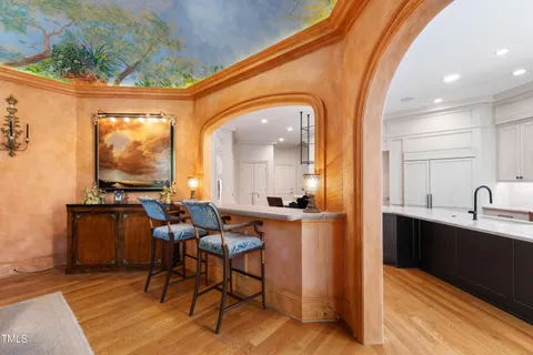 a bedroom with a bed and large windows