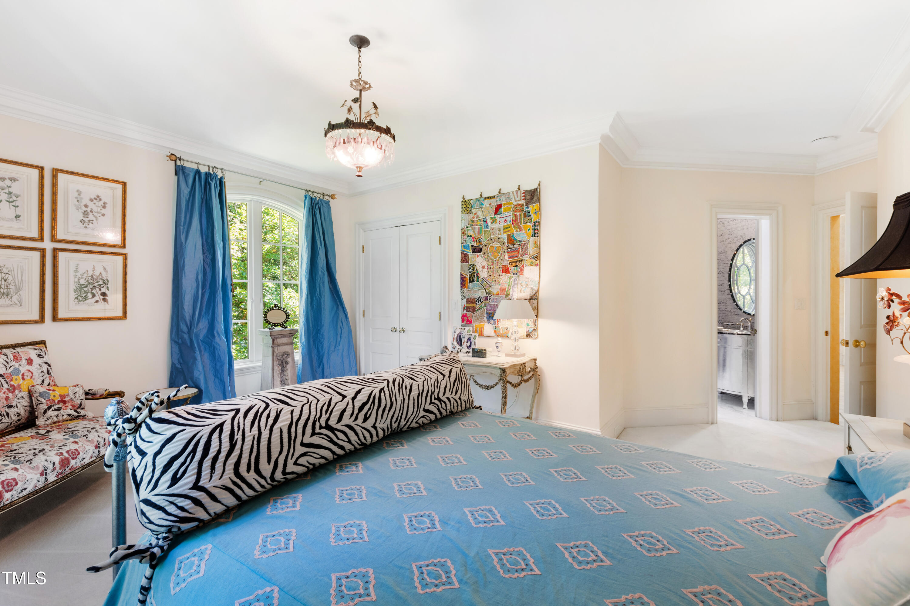 2658 Davis Street Raleigh, NC 27608 - Photo 49 of 99 a bedroom with a bed and a chandelier