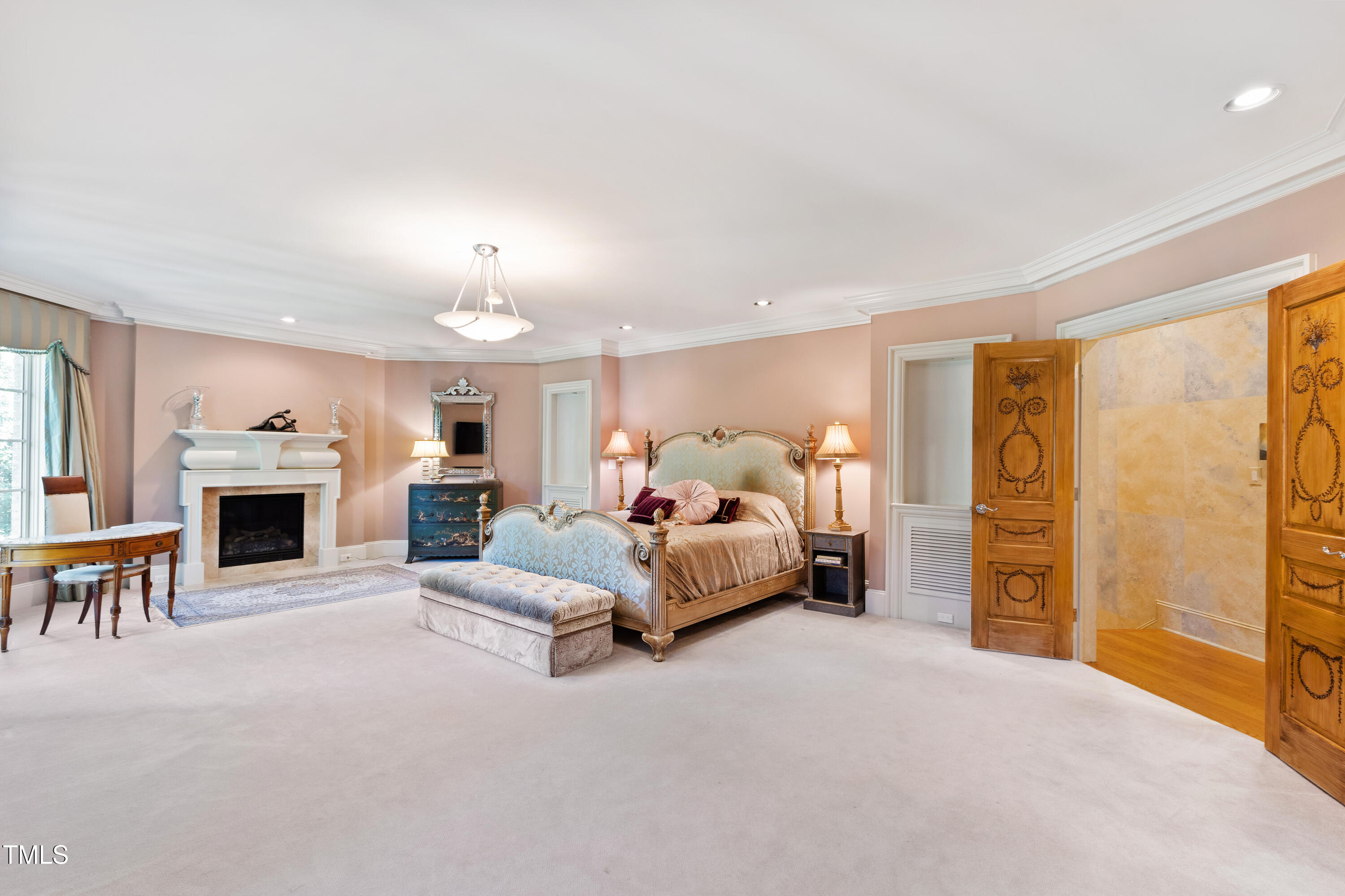 2658 Davis Street Raleigh, NC 27608 - Photo 61 of 99 a spacious bedroom with a bed and a chandelier