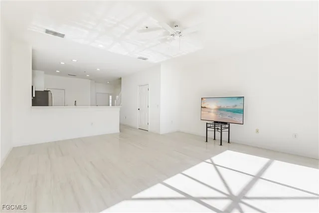a view of kitchen with furniture and refrigerator
