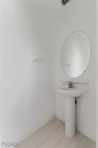 a bathroom with a sink a mirror and vanity