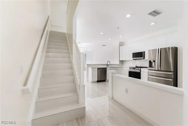 a kitchen with cabinets and stainless steel appliances