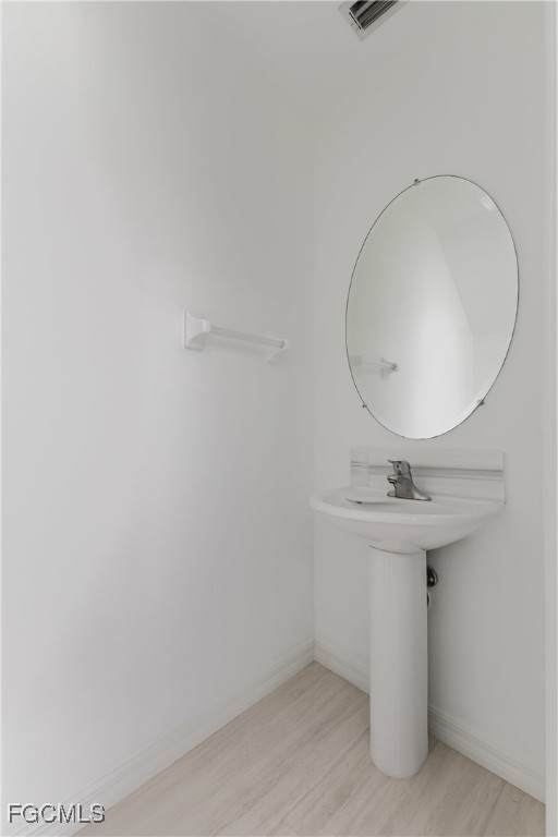 827 Hampton Circle, Unit 146 Naples, FL 34105 - Photo 15 of 36 a bathroom with a sink a mirror and vanity