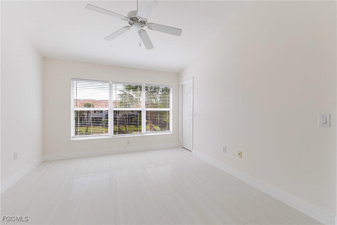 827 Hampton Circle, Unit 146 Naples, FL 34105 - Photo 17 of 36 an empty room with a window and a ceiling fan
