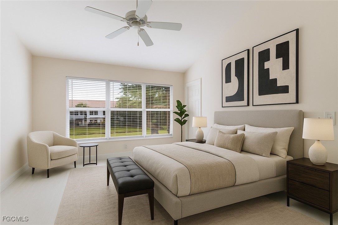 827 Hampton Circle, Unit 146 Naples, FL 34105 - Photo 18 of 36 a bedroom with a bed and a large window