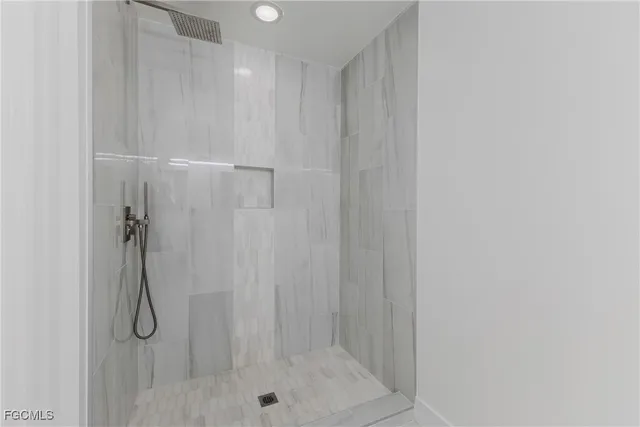 a bathroom with a glass shower door
