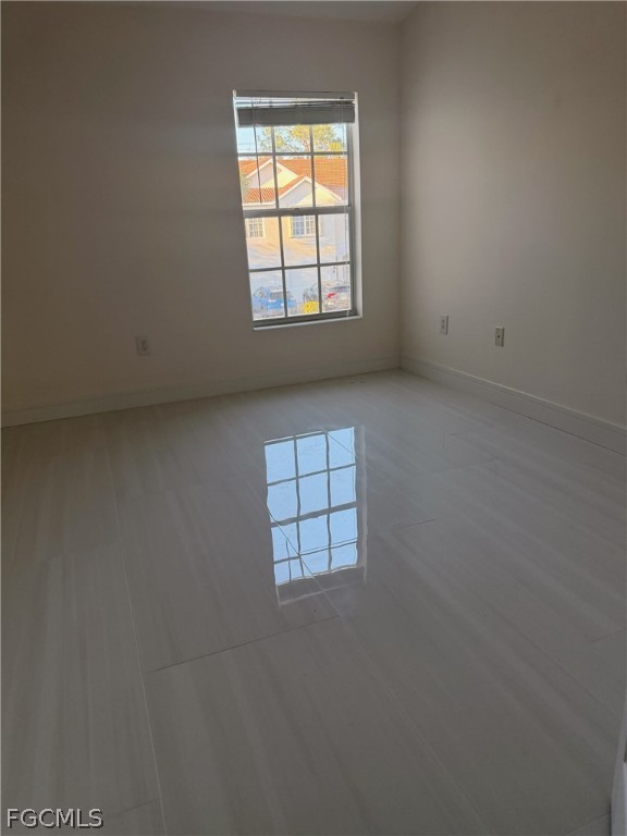 827 Hampton Circle, Unit 146 Naples, FL 34105 - Photo 23 of 36 an empty room with windows