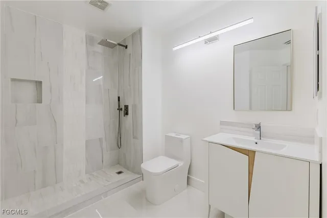 a bathroom with a toilet a sink and shower