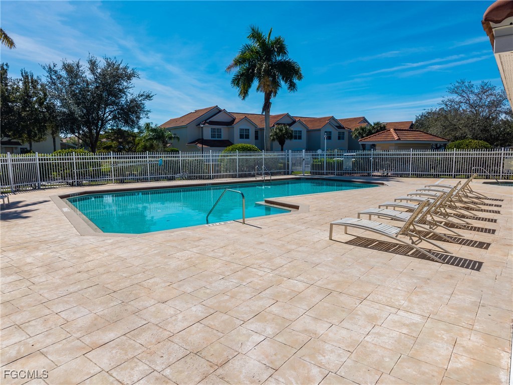 827 Hampton Circle, Unit 146 Naples, FL 34105 - Photo 33 of 36 a view of swimming pool with a yard and seating area