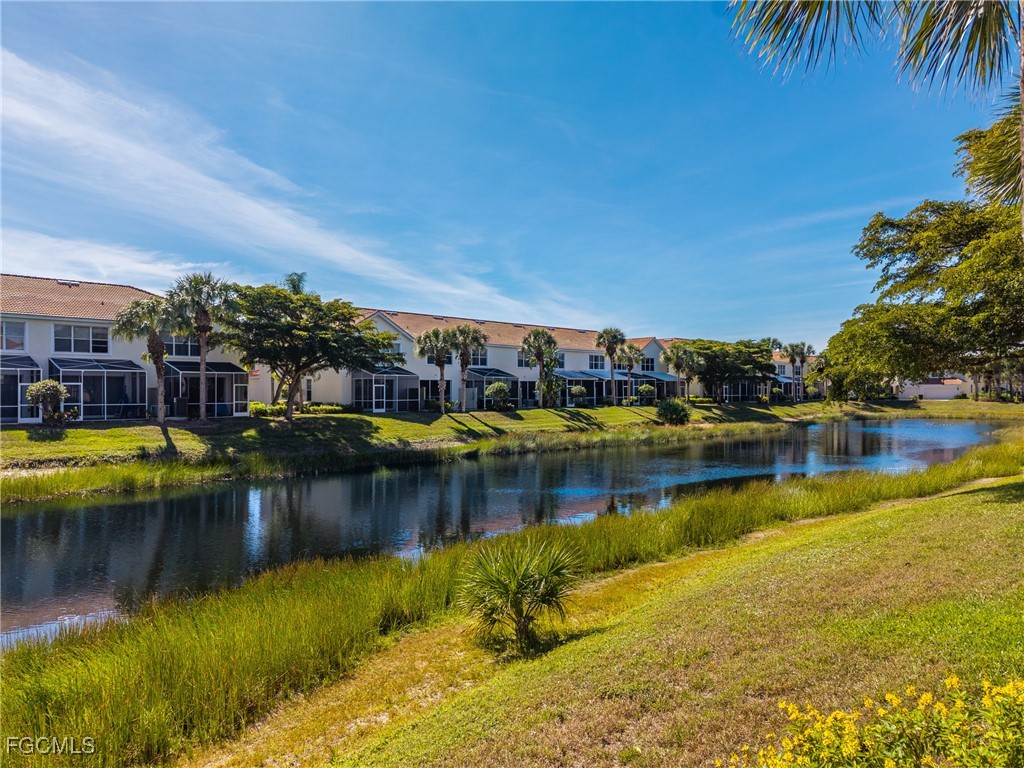 827 Hampton Circle, Unit 146 Naples, FL 34105 - Photo 35 of 36 a view of a lake with houses