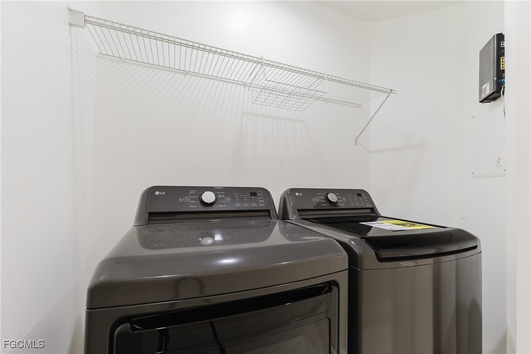 827 Hampton Circle, Unit 146 Naples, FL 34105 - Photo 36 of 36 a utility room with dryer and washer