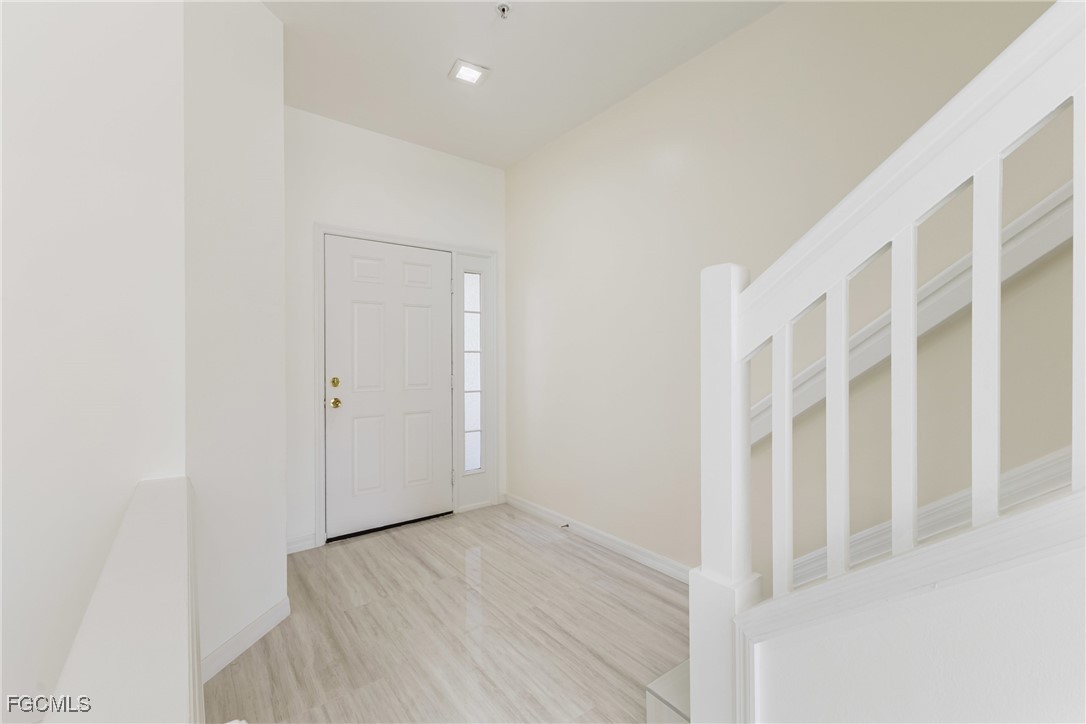 827 Hampton Circle, Unit 146 Naples, FL 34105 - Photo 4 of 36 a view of an empty room with wooden floor