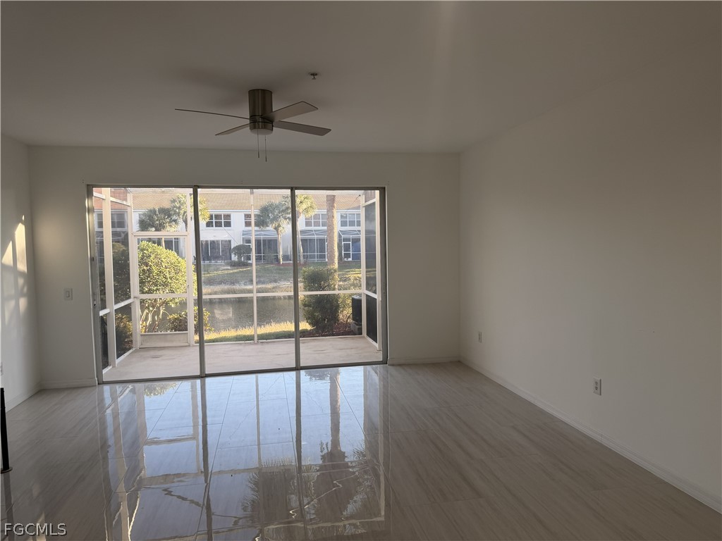 827 Hampton Circle, Unit 146 Naples, FL 34105 - Photo 10 of 36 a view of empty room with wooden floor and fan