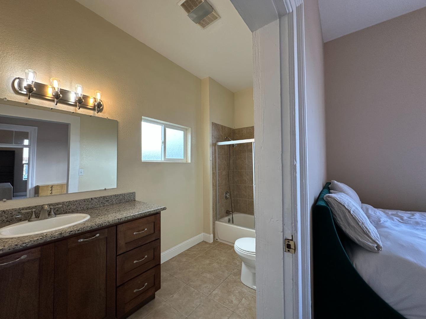 69 Geil Street Salinas, CA 93901 - Photo 12 of 34 a bathroom with a granite countertop sink a toilet and a mirror
