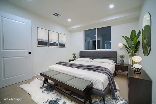 a bathroom with a shower a sink a toilet and mirror