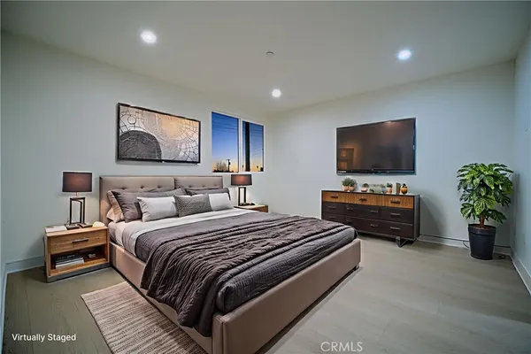 a bedroom with a bed and a flat screen tv